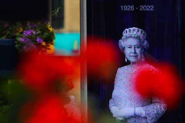 A billboard shows a picture of late Britain’s Queen Elizabeth II is displayed in Cardiff.