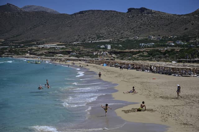 Tourists enjoy the beach in Phalasarna, northwest of the Greek mediterranean island of Crete