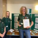 Lindsey Stockton (far right, holding framed document) with food bank colleagues
