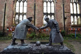 A resin model of a sculpture illustrating the WW1 Christmas Truce football match is pictured during a photocall inside the remains of St Luke's Church in Liverpool