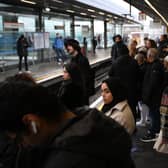 Commuters wait for an extremely delayed Central Line train at Stratford station in London on December 13  as rail strikes began a wave of festive walkouts in the country.