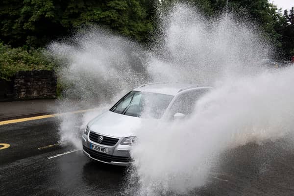 A car drives through floodwater (Photo by Matthew Horwood/Getty Images)