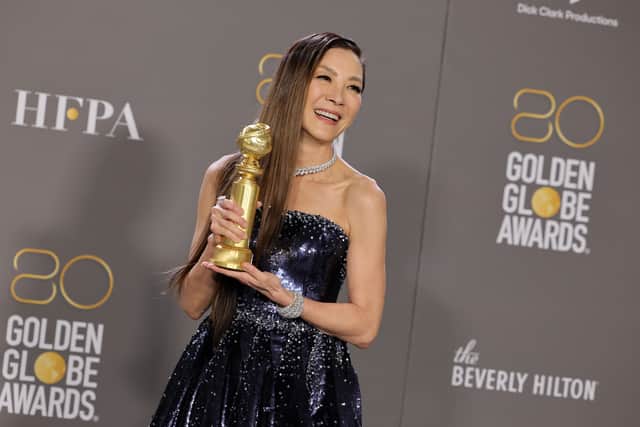 Michelle Yeoh poses with the Best Actress in a Motion Picture â Musical or Comedy award for "Everything Everywhere All at Once"