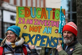 Teachers and members of the National Education Union (NEU) hold placards during a demonstration called by the NEU trade unions in the streets of Reading, on February 1, 2023 during a national strike day.  (Photo by Adrian DENNIS / AFP) (Photo by ADRIAN DENNIS/AFP via Getty Images)