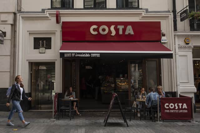 LONDON, ENGLAND - AUGUST 31: Customers sit outside a Costa Coffee store on August 31, 2018 in London, England. Coca-Cola Co. is to buy the U.K. chain Costa Coffee for £3.9 billion GBP, ($5.1 billion USD). (Photo by Dan Kitwood/Getty Images)