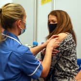 Caroline Nicolls receives an injection of the Moderna Covid-19 vaccine administered by nurse Amy Nash, at the Madejski Stadium, Reading (Getty Images)