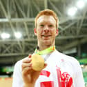 Gold medalist Edward Clancy of Team Great Britain poses for photographs after the medal ceremony for the Men's Team Pursuit on Day 7 of the Rio 2016 Olympic Games (Photo by Bryn Lennon/Getty Images)