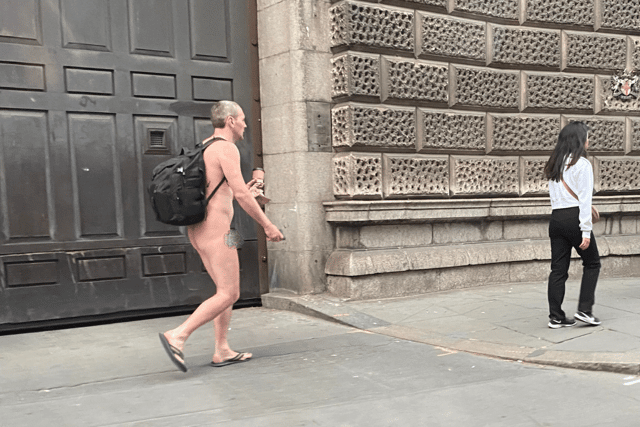 Kitted out in just a rucksack and flip flops while carrying a takeaway coffee, the commuter appeared to be grinning at fellow Londoners as he walked through the city naked.