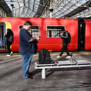 Commuters walk past a train stopped at a platform in Waterloo Station in London, during a national strike day, on February 1, 2023.