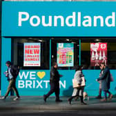 Shoppers walk past a Poundland shop in Brixton, south London.