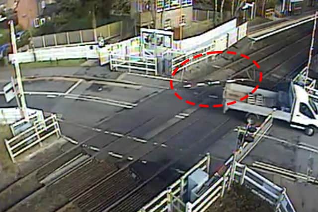 A van ignoring the signals and lowering barriers, ripping down the level crossing barrier and dragging it across the crossing (Blakedown level crossing, Worcestershire).
