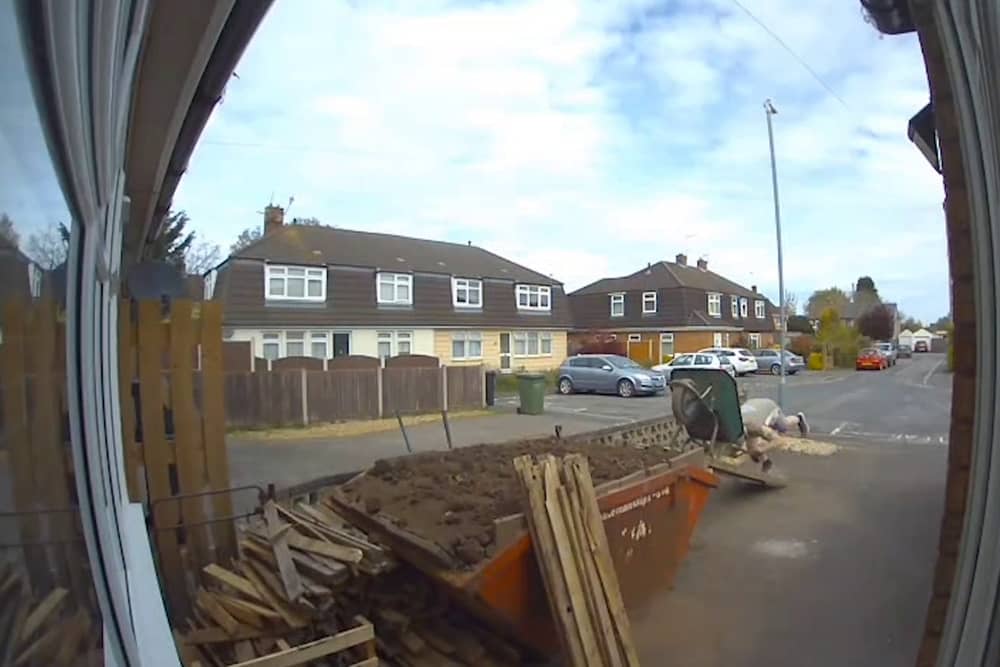 Man covers himself in soil after wheelbarrow tips over.