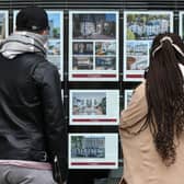 People look at residential properties displayed for sale in the window of an estate agents' in London (Photo: ISABEL INFANTES/AFP via Getty Images)