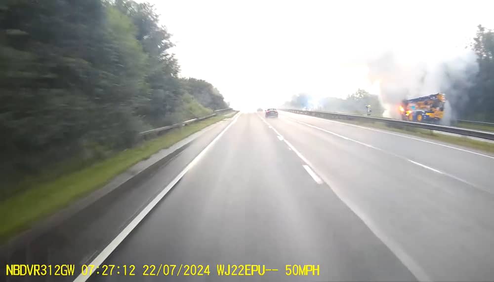 Fire rages through crane on A road as smoke billows into air.