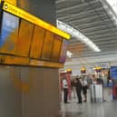 Just Stop Oil cover Heathrow Airport Terminal 5's departure boards in orange paint.