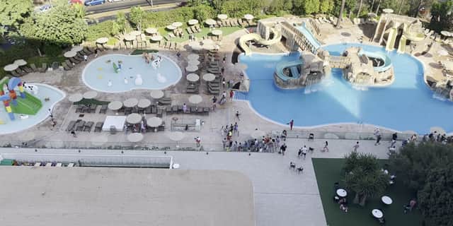 Tourists race to get sunbeds after queuing for pool to open.