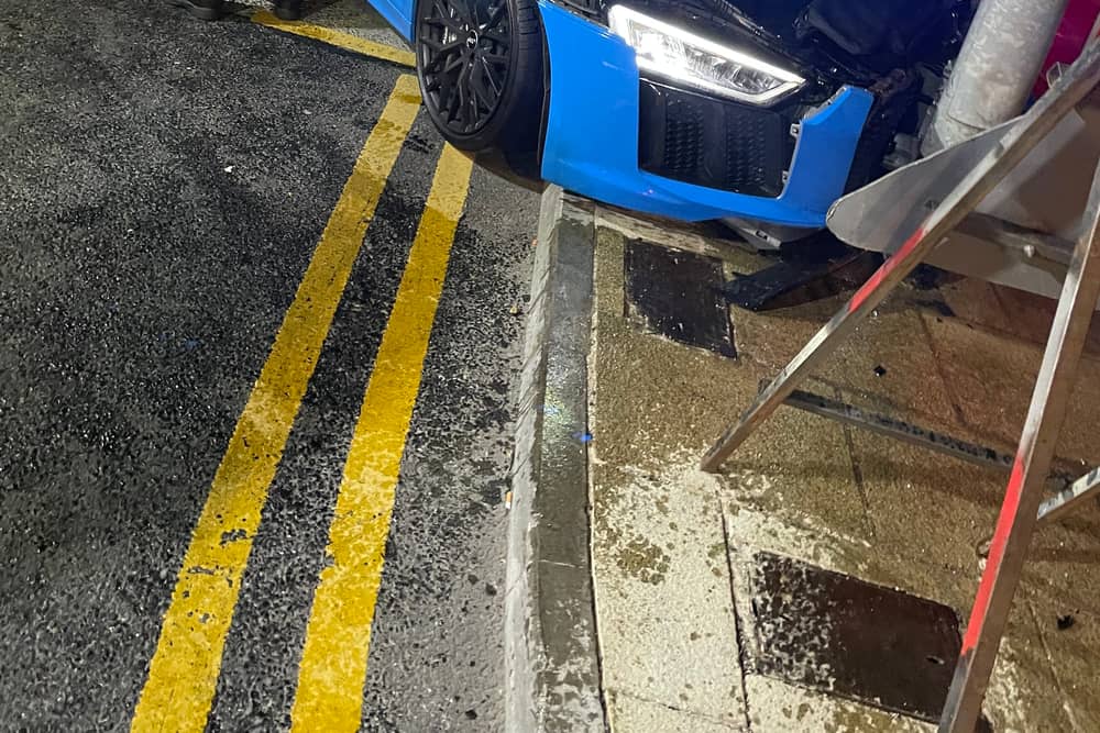 A light blue Audi R8 supercar hit a street post. 