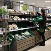 An employee stacks shelves at a Waitrose supermarket in London (Photo: HOLLIE ADAMS/AFP via Getty Images)