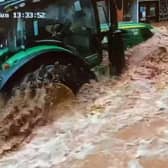 CCTV captures a tractor driving fast through floodwater in Tenbury Wells, Worcestershire.