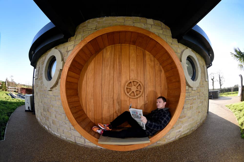 AirB&B host Mike Afflick reads his Lancashire Post while taking a break at his Hobbit House in Inglewhite, near Preston. 