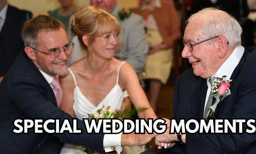 A couple on their wedding day clasping hands with the bride's father