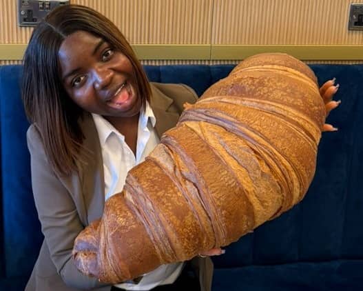 Emmanuella Okpoko with the massive croissant at P&D Gran Caffè in Liverpool.