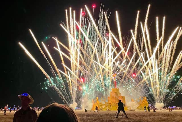 A security guard keeps people back during the annual Burning Man Festival on September 4, 2023 after the sun shone on the colourful makeshift community of 70,000 people called Black Rock City.