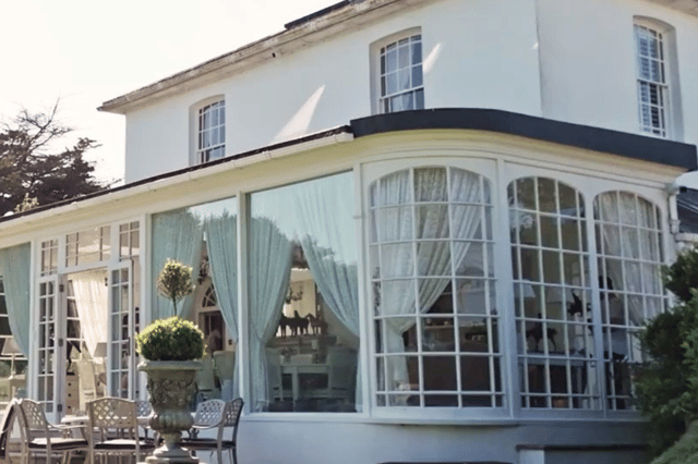 The light-filled orangery at Merston House offers stunning garden views and elegant period detailing – the perfect setting for relaxed Sussex living.