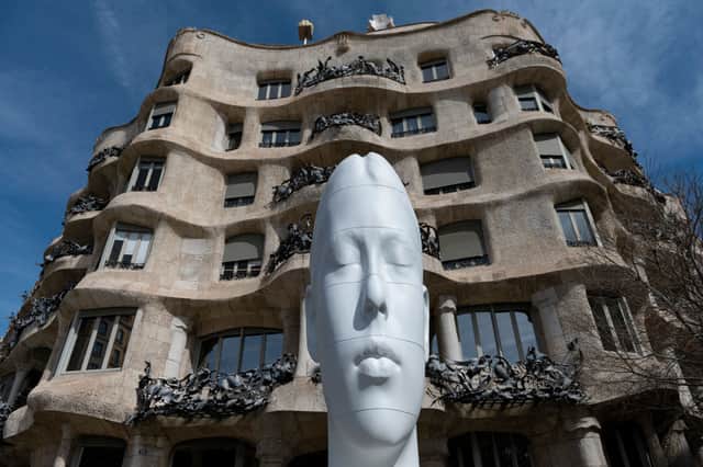 A sculpture entitled 'Flora', by Spanish artist Jaume Plensa is displayed during 'Jaume Plensa, poetry of silence' exhibition in front of Spanish architect Antonio Gaudi's "Casa Mila" building, commonly known as "La Pedrera" in Barcelona.