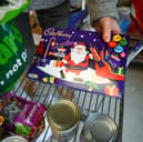 A Christmas chocolate selection box is unpacked in Weymouth Foodbank distribution hub in December 2023 (Photo: Finnbarr Webster/Getty Images)