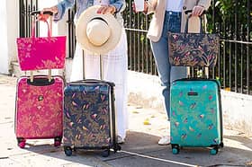 These new colourful pink, blue and green suitcases from Sara Miller London are standout luggage - and they fit within Ryanair size requirements.
