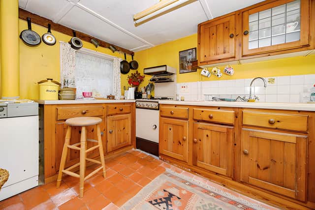 The well-proportioned kitchen forms part of a practical ground-floor layout alongside a separate dining area