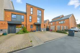 The School End Crescent home combines three floors of contemporary accommodation with driveway parking and an end-of-terrace position