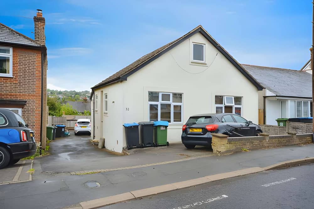 The detached bungalow on Belswains Lane has driveway parking for multiple vehicles and a flexible layout spread across two floors