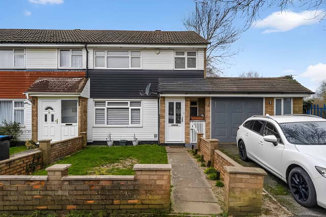 The end-of-terrace house on Frome Square has a driveway and a substantial side garage