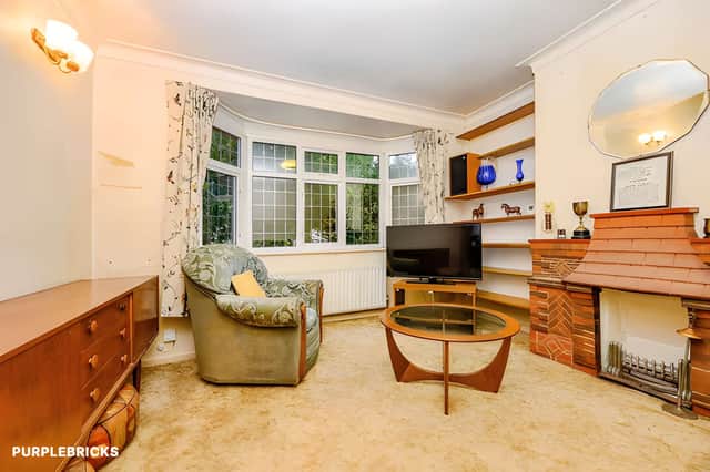 A spacious living room provides the main reception area, complemented by a separate dining room elsewhere on the ground floor