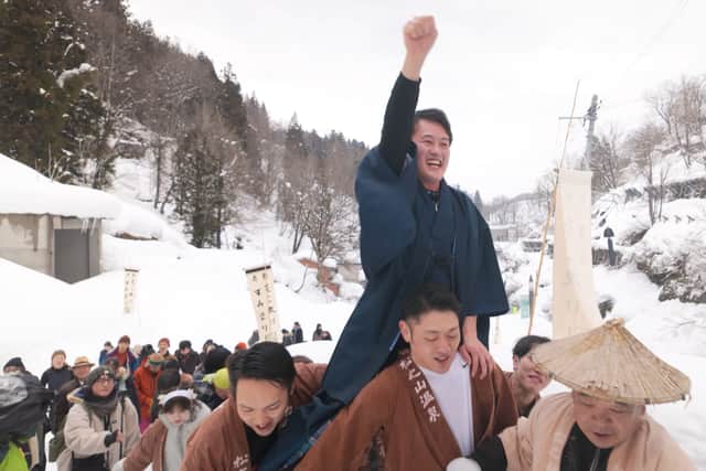 A bridegroom is carried during the Matsunoyama Winter Festival