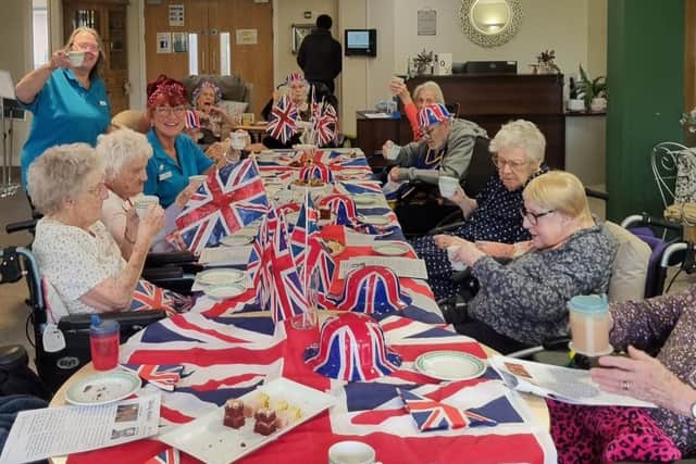 Residents and staff enjoying a tea party to commemorate VE Day