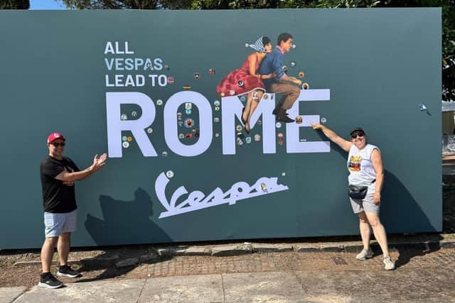 Rui Baptista (R) and partner at the Vespa advertising board in Rome.