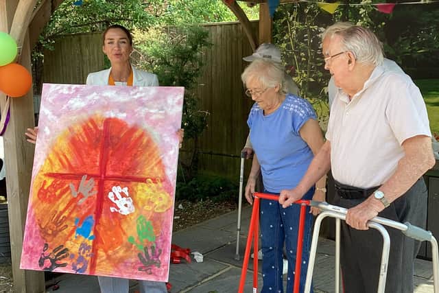 Deputy Mayor of Watford receiving a painting from residents of Montrose Care Home B&M Care.