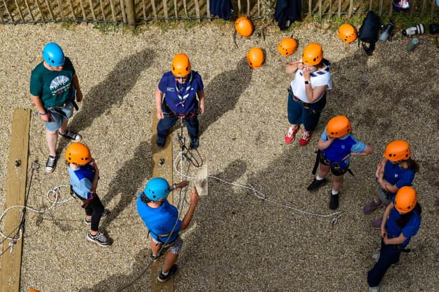 CEO Felicity Oswald OBE and Chief Guide Tracy Foster OBE going up the climbing wall with girls
