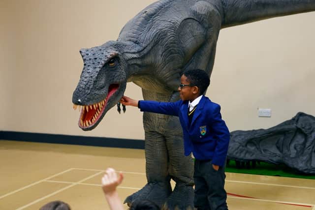 Reggie the animatronic T-Rex with a pupil at one of the Giant Journeys workshops.