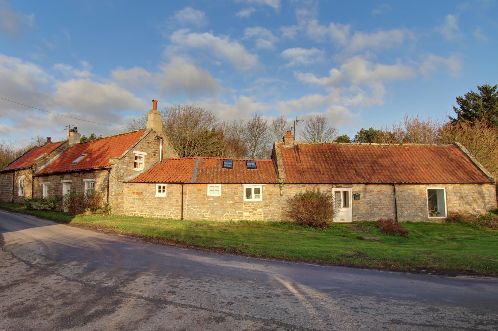 The attractive exterior view of the period building that has extensive gardens.