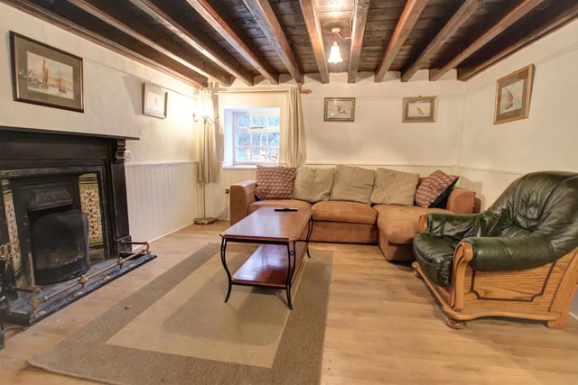 The large period firepace is a focal point in this main room within the cottage.