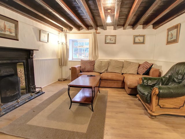 The large period firepace is a focal point in this main room within the cottage.