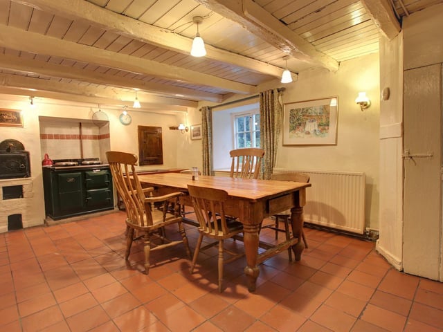 The beamed farmhouse style kitchen has a bread oven as an original feature of the cottage.