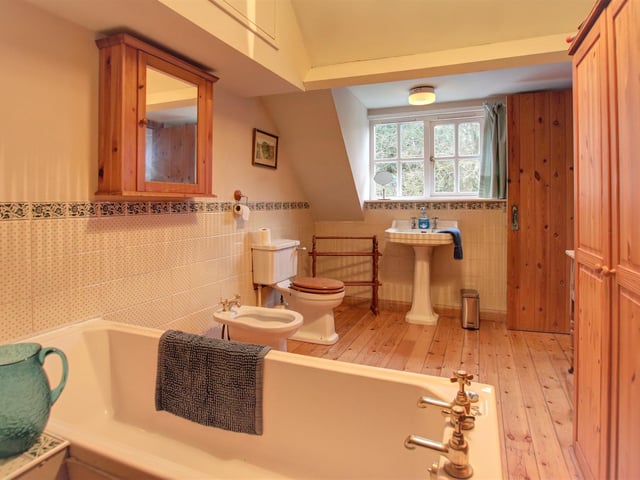 The four piece bathroom suite includes a deep bath and a bidet.