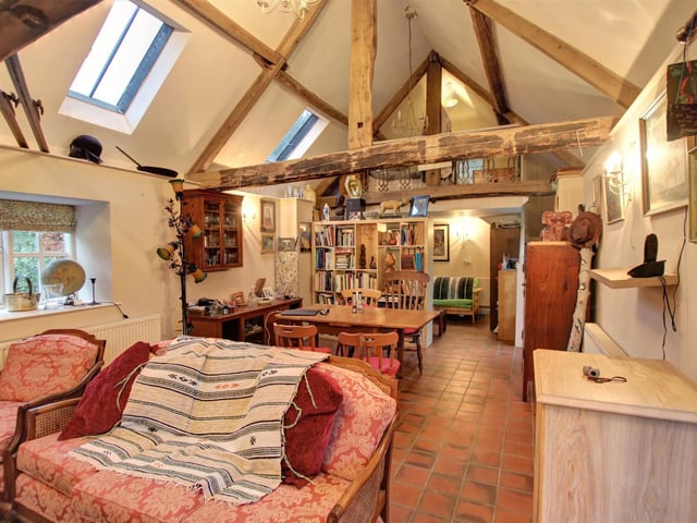 The interior of the beamed annexe is divided by furniture in to different living sections.