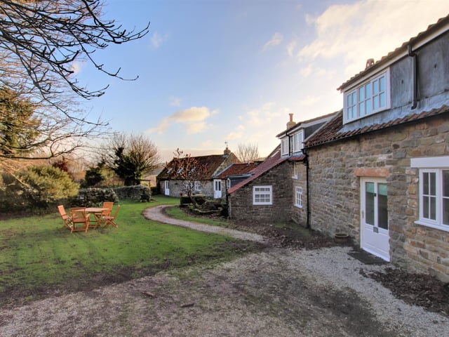 Looking across the lawned area behind the cottage buildings.