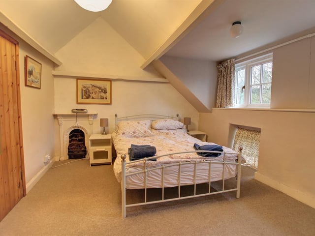 This double bedroom has an original fireplace within its fabric.